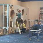 action photo of workers finishing the cubbies.